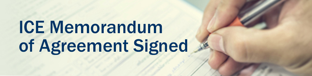 ICE Memorandum of Agreement Signed with a man's hand signing a document